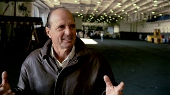 Movie still from “Little Dieter Needs to Fly” (1997), directed by Werner Herzog – An older man in a leather jacket talking to someone; Close Up shot, Over the shoulder angle