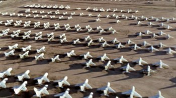 Movie still from “Little Dieter Needs to Fly” (1997), directed by Werner Herzog – A field with many white airplanes on the ground; Extreme Wide shot, High angle
