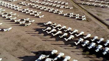 Movie still from “Little Dieter Needs to Fly” (1997), directed by Werner Herzog – An aerial view of a lot of white airplanes; Extreme Wide shot, High angle