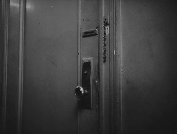 Movie still from “Little Fugitive” (1953), directed by Morris Engel – A black and white photo of a door handle; Extreme Close Up shot, High angle