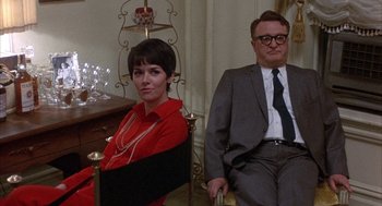 Movie still from “Little Murders” (1971), directed by Alan Arkin – A man and a woman sitting next to each other; Medium shot, Low angle
