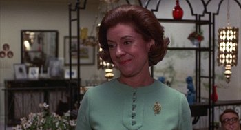 Movie still from “Little Murders” (1971), directed by Alan Arkin – A person wearing a suit and tie; Close Up shot, Over the shoulder angle