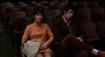 Movie still from “Little Murders” (1971), directed by Alan Arkin – A man and a woman sitting next to each other; Medium shot, High angle