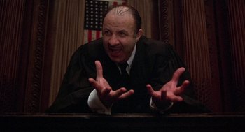 Movie still from “Little Murders” (1971), directed by Alan Arkin – A man in a court room wearing a judge's robe; Close Up shot, Low angle