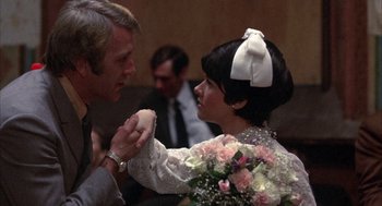 Movie still from “Little Murders” (1971), directed by Alan Arkin – A man and a woman are holding hands; Close Up shot, Over the shoulder angle