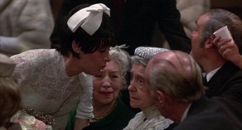 Movie still from “Little Murders” (1971), directed by Alan Arkin – A group of people that are gathered around each other; Close Up shot, Over the shoulder angle