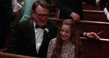 Movie still from “Little Murders” (1971), directed by Alan Arkin – A man and a woman are smiling for the camera; Close Up shot, High angle