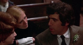 Movie still from “Little Murders” (1971), directed by Alan Arkin – A man and a woman are sitting in a chair; Close Up shot, Over the shoulder angle
