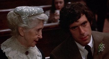 Movie still from “Little Murders” (1971), directed by Alan Arkin – An older woman and a young man in a courtroom; Close Up shot, Over the shoulder angle