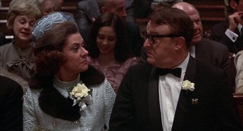 Movie still from “Little Murders” (1971), directed by Alan Arkin – A man and a woman in formal wear standing next to each other; Close Up shot, Over the shoulder angle