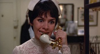 Movie still from “Little Murders” (1971), directed by Alan Arkin – A woman holding a phone up to her ear; Close Up shot, Low angle