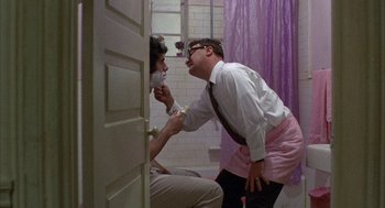 Movie still from “Little Murders” (1971), directed by Alan Arkin – A man and a woman in a bathroom; Medium shot, Over the shoulder angle