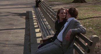 Movie still from “Little Murders” (1971), directed by Alan Arkin – A man and a woman are sitting on a bench; Wide shot, Over the shoulder angle
