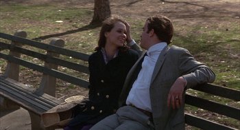 Movie still from “Little Murders” (1971), directed by Alan Arkin – A man and a woman sitting on a park bench; Medium shot, High angle