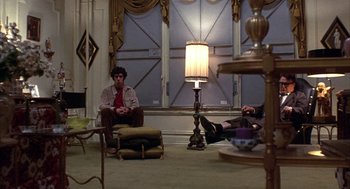 Movie still from “Little Murders” (1971), directed by Alan Arkin – Two people sitting in a living room next to each other; Wide shot, High angle