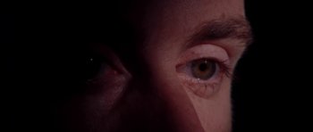 Movie still from “Little Odessa” (1994), directed by James Gray – A person's eyes in the dark; Extreme Close Up shot, Overhead angle