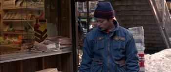 Movie still from “Little Odessa” (1994), directed by James Gray – A young man in a denim jacket and a hat; Medium shot, Over the shoulder angle