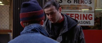 Movie still from “Little Odessa” (1994), directed by James Gray – A man in a leather jacket talking to another man; Close Up shot, Over the shoulder angle