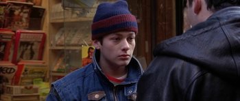 Movie still from “Little Odessa” (1994), directed by James Gray – A young man wearing a blue jacket and a red and blue hat; Close Up shot, Over the shoulder angle