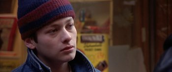 Movie still from “Little Odessa” (1994), directed by James Gray – A young man wearing a hat looking to his left; Close Up shot, Over the shoulder angle