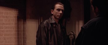 Movie still from “Little Odessa” (1994), directed by James Gray – A man wearing a leather jacket standing in a room; Close Up shot, Low angle