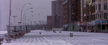 Movie still from “Little Odessa” (1994), directed by James Gray – A snowy street with buildings in the background; Extreme Wide shot, High angle