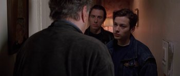 Movie still from “Little Odessa” (1994), directed by James Gray – A group of men standing next to each other; Medium shot, Over the shoulder angle