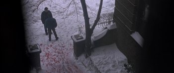 Movie still from “Little Odessa” (1994), directed by James Gray – A person walking in the snow next to a tree; Extreme Wide shot, High angle