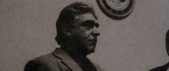 Movie still from “Little Odessa” (1994), directed by James Gray – An old black and white photo of a man in front of a clock; Close Up shot, Low angle