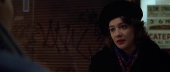 Movie still from “Little Odessa” (1994), directed by James Gray – A woman wearing a black hat and a black jacket; Close Up shot, Over the shoulder angle
