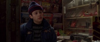 Movie still from “Little Odessa” (1994), directed by James Gray – A young man wearing a hat in a store; Close Up shot, Over the shoulder angle
