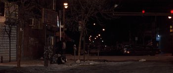 Movie still from “Little Odessa” (1994), directed by James Gray – A person standing on the side of the street at night; Extreme Wide shot, High angle
