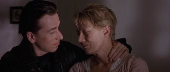 Movie still from “Little Odessa” (1994), directed by James Gray – A man and a woman sitting next to each other; Close Up shot, Low angle