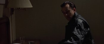 Movie still from “Little Odessa” (1994), directed by James Gray – A man sitting in a dark room looking down at the floor; Close Up shot, Low angle