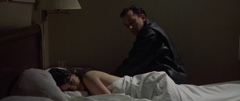 Movie still from “Little Odessa” (1994), directed by James Gray – A woman laying in a bed next to a man; Medium shot, Low angle