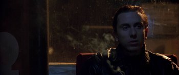 Movie still from “Little Odessa” (1994), directed by James Gray – A man sitting in a chair with a cigarette in his mouth; Close Up shot, Low angle