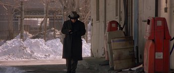 Movie still from “Little Odessa” (1994), directed by James Gray – A man wearing a hat and a long black coat; Wide shot, Low angle