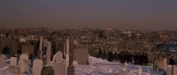 Movie still from “Little Odessa” (1994), directed by James Gray – A group of people standing around a cemetery; Extreme Wide shot, High angle