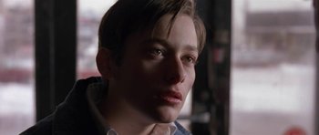 Movie still from “Little Odessa” (1994), directed by James Gray – A person with short brown hair; Close Up shot, Low angle