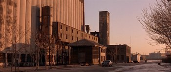 Movie still from “Little Odessa” (1994), directed by James Gray – An old building in the middle of a street; Extreme Wide shot, Low angle