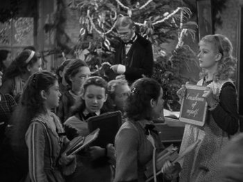 Movie still from “Little Women” (1933), directed by George Cukor – A black and white photo of a group of people; Medium shot, High angle