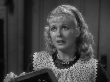 Movie still from “Little Women” (1933), directed by George Cukor – An old photo of a woman holding an open book; Close Up shot, High angle