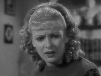 Movie still from “Little Women” (1933), directed by George Cukor – A black and white photo of a woman in a headband; Close Up shot, Over the shoulder angle