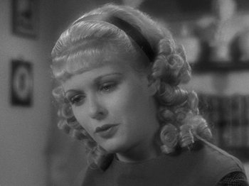 Movie still from “Little Women” (1933), directed by George Cukor – A black and white photo of a woman with blonde hair; Close Up shot, Over the shoulder angle