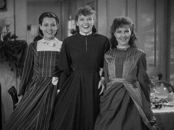 Movie still from “Little Women” (1933), directed by George Cukor – A group of women standing next to each other; Medium shot, Low angle