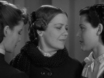 Movie still from “Little Women” (1933), directed by George Cukor – A woman with two other women standing next to her face; Close Up shot, Over the shoulder angle