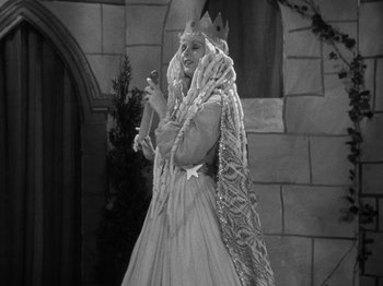 Movie still from “Little Women” (1933), directed by George Cukor – A woman dressed as the white queen from the movie snow white; Medium shot, Low angle
