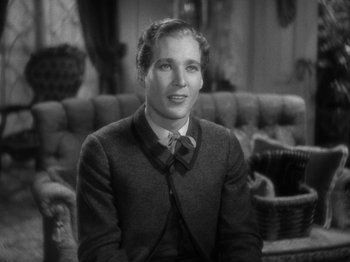 Movie still from “Little Women” (1933), directed by George Cukor – A man in a suit sitting on a couch; Close Up shot, High angle