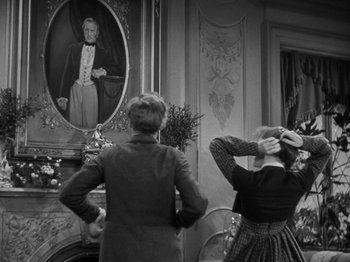Movie still from “Little Women” (1933), directed by George Cukor – A man and a woman looking in a mirror; Medium shot, Over the shoulder angle