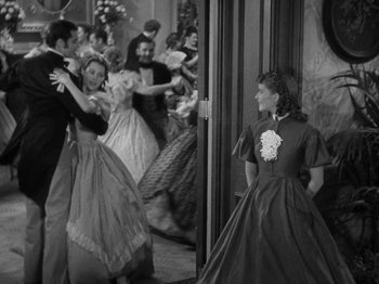 Movie still from “Little Women” (1933), directed by George Cukor – A group of people dressed in period clothing; Wide shot, Over the shoulder angle